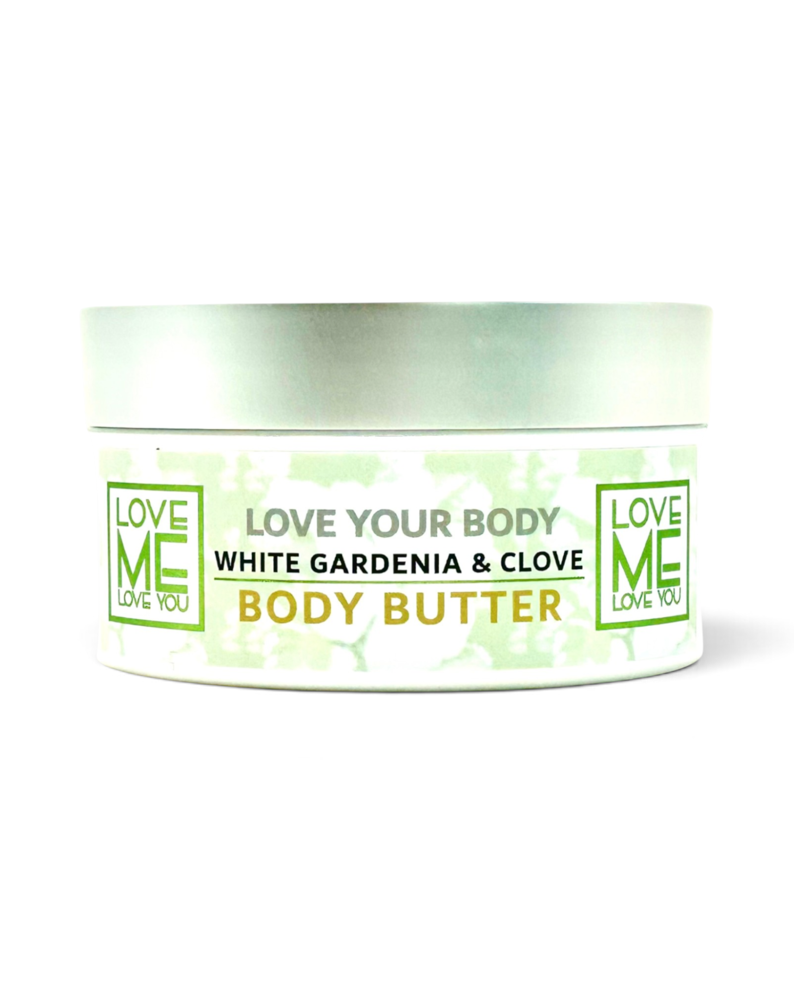 A white jar of Love Me Body Butter with a silver lid, featuring a label that reads 'White Gardenia & Clove Body Butter' in black and green text.