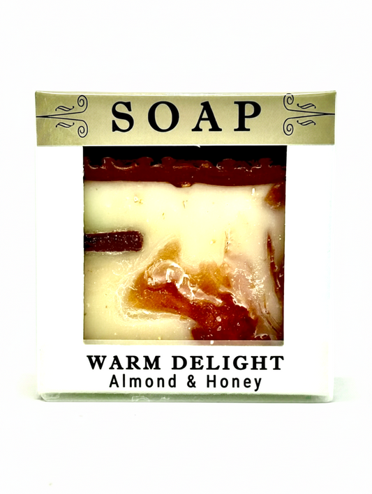 A packaged bar of soap labeled 'SOAP' and 'WARM DELIGHT Almond & Honey' on a plain white background.